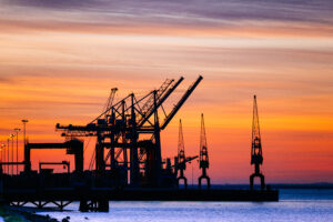 Beautiful silhouette of port machinery during sunset